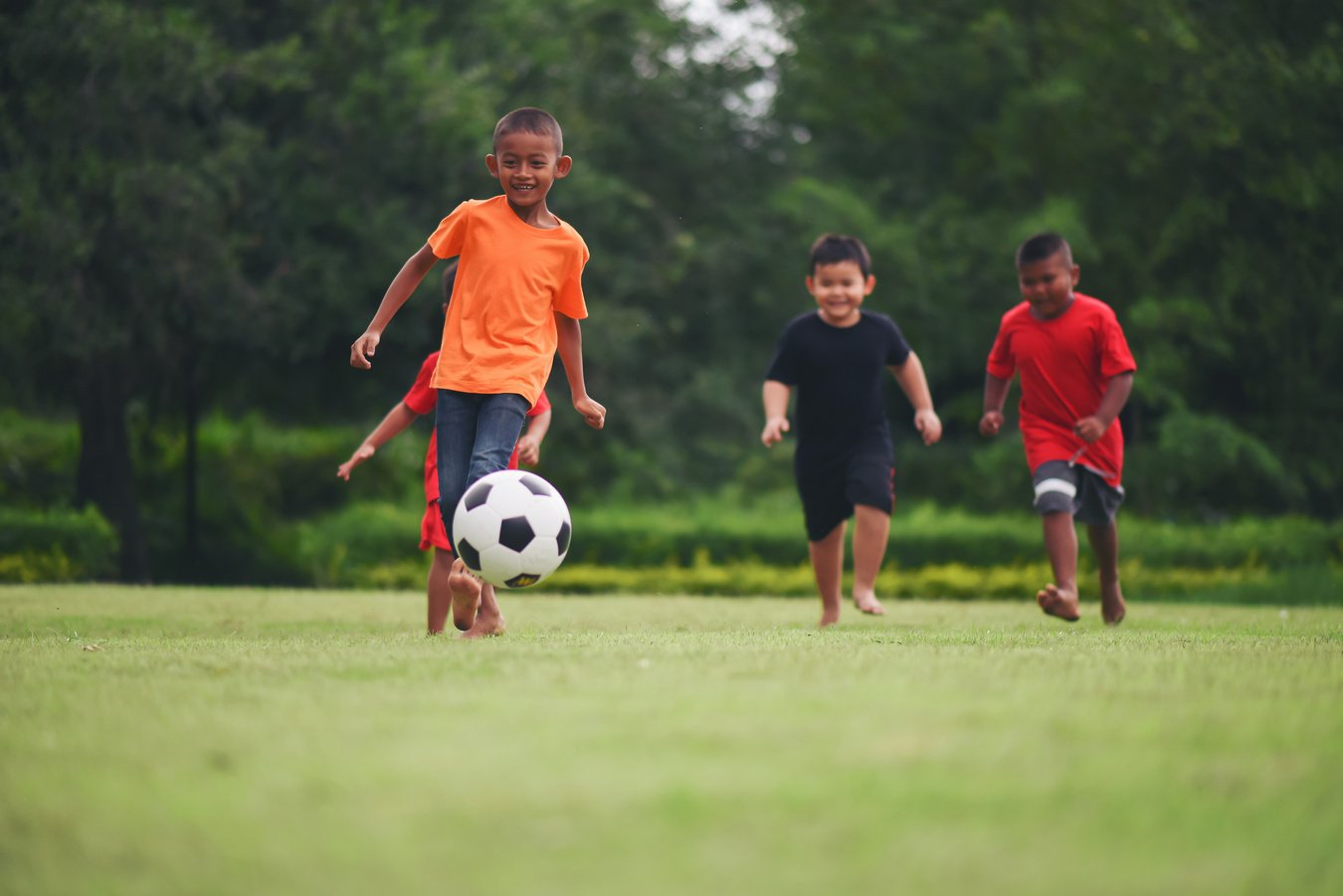 Kids playing soccer football